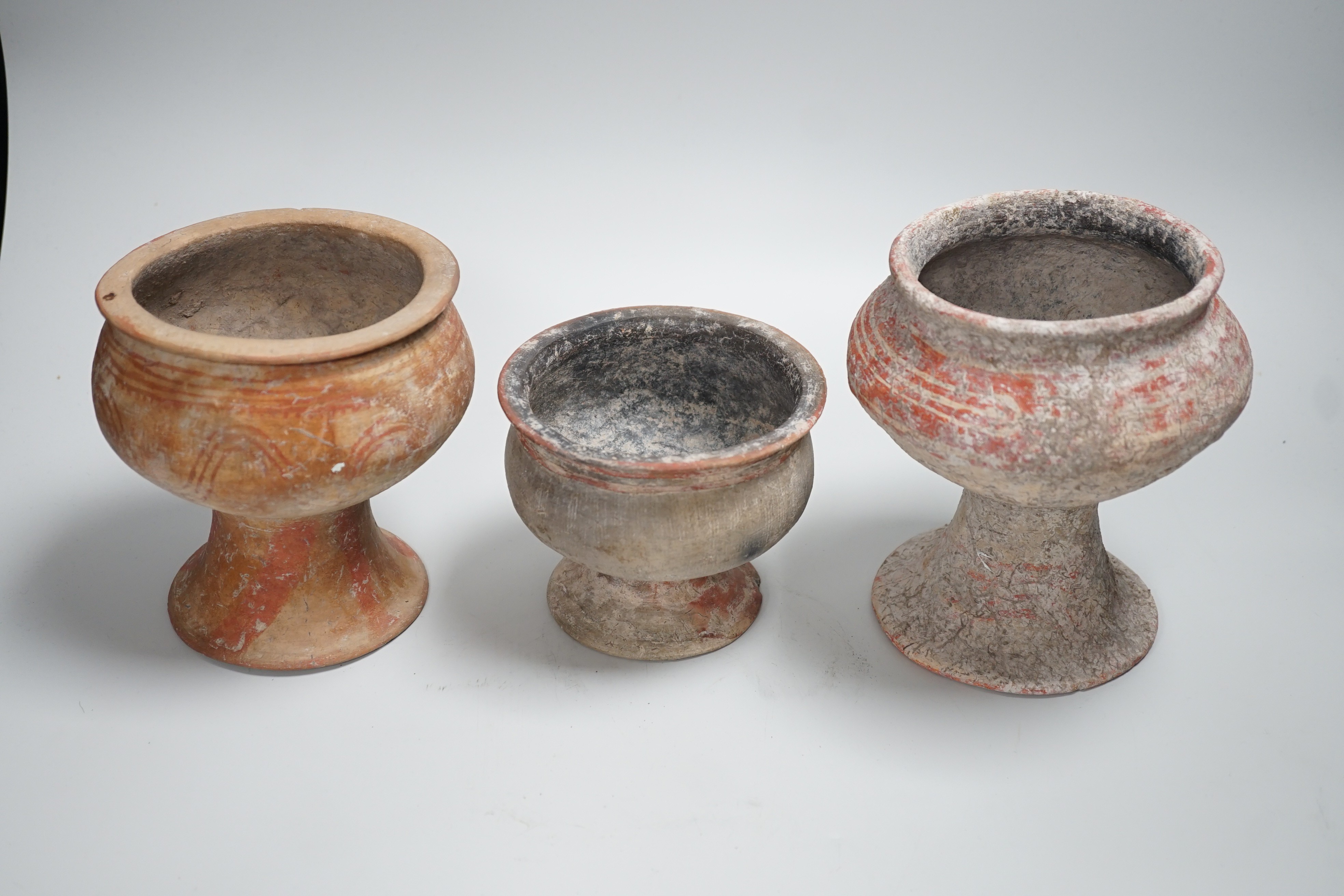 Three Ban Chiang pottery pedestal vessels, Thailand, 300 BCE–200 CE, tallest 16cm